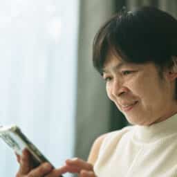 Woman with a hearing aid using a phone