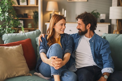 A couple sitting together on the couch.