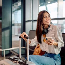 Young woman waiting for her flight at the airport