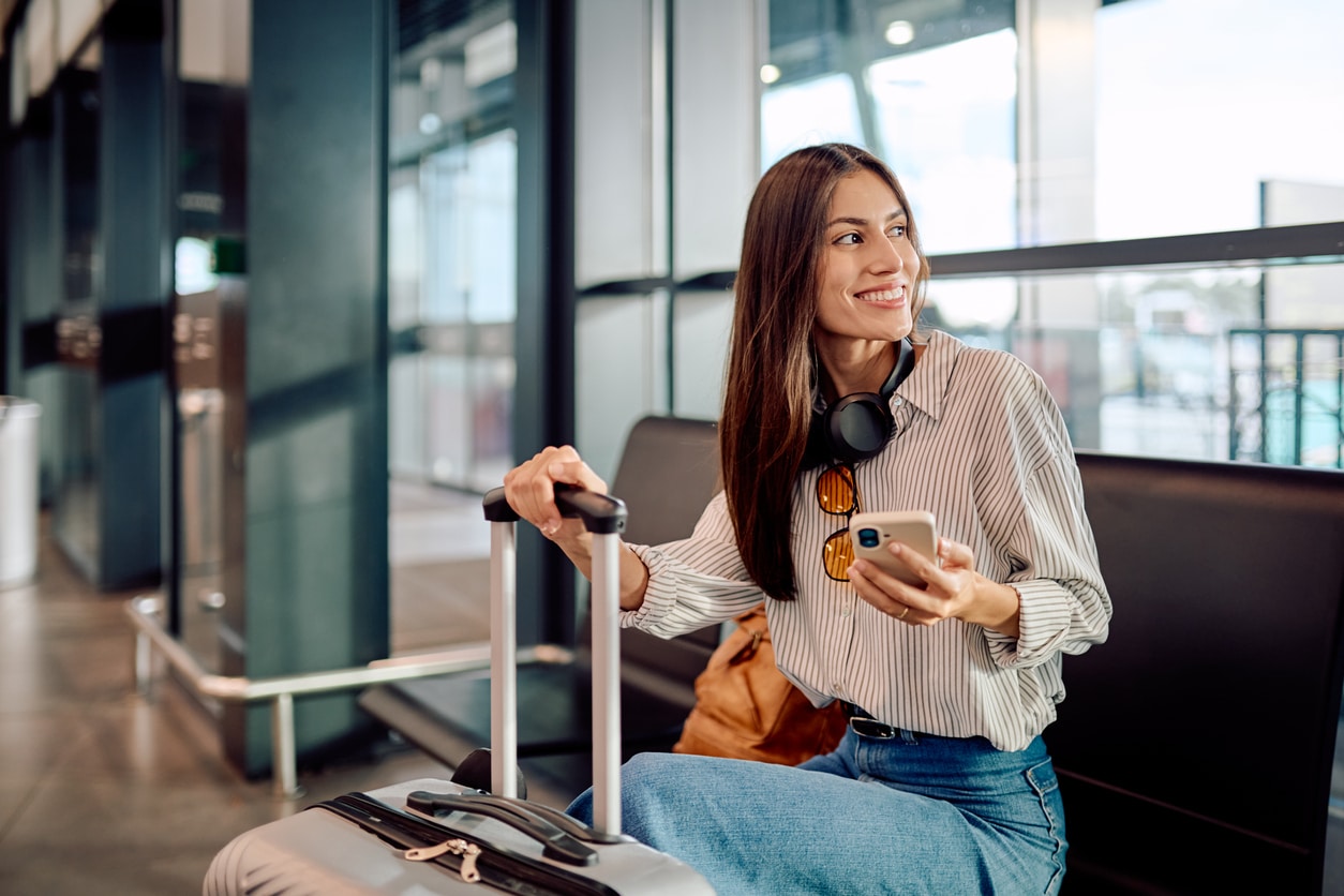 Young woman waiting for her flight at the airport.